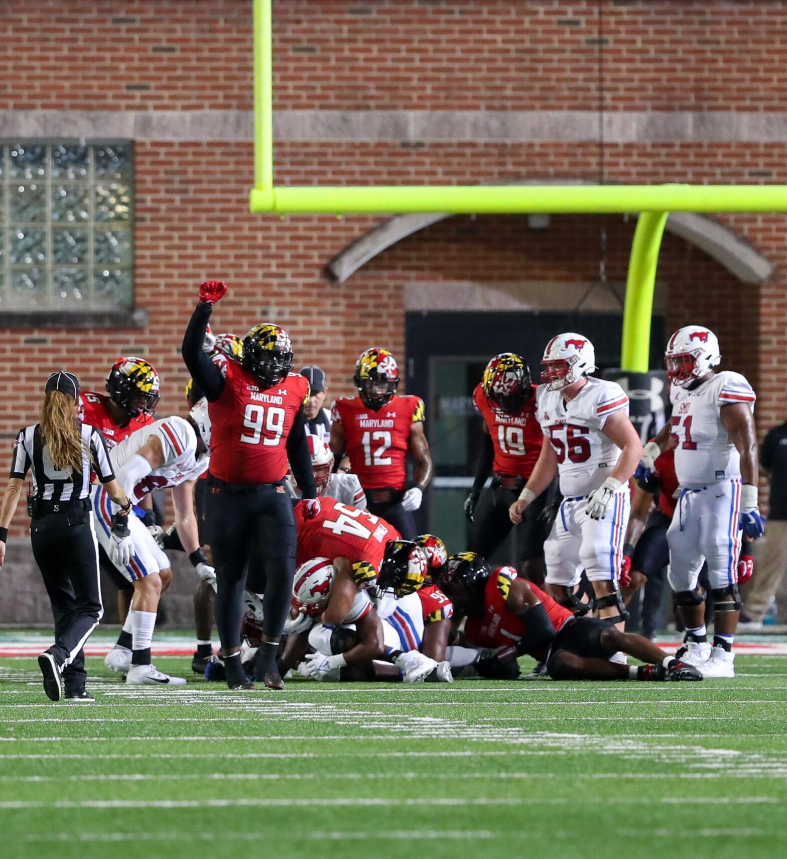 Maryland football defensive tackle Tommy Akingbesote celebrates a stop